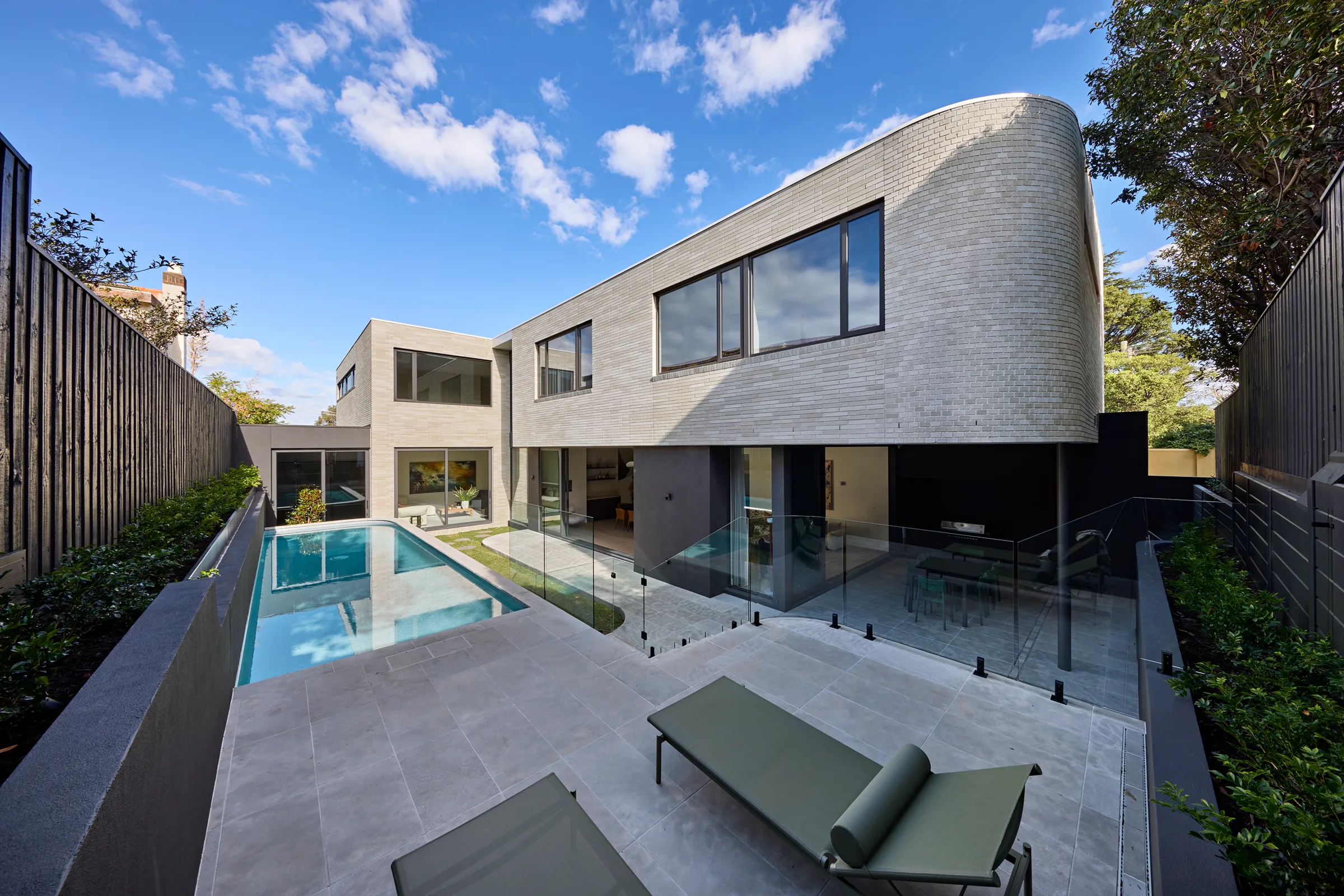 Madden Grove, Kew. The rear elevation and pool from the terrace.