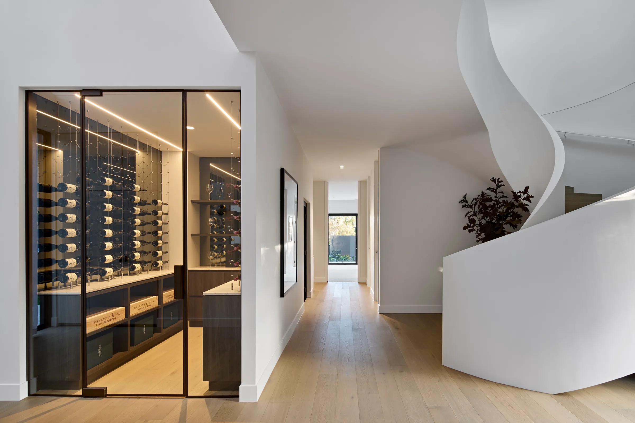 Madden Grove, Kew. Hallway past the glazed wine room to the stair.
