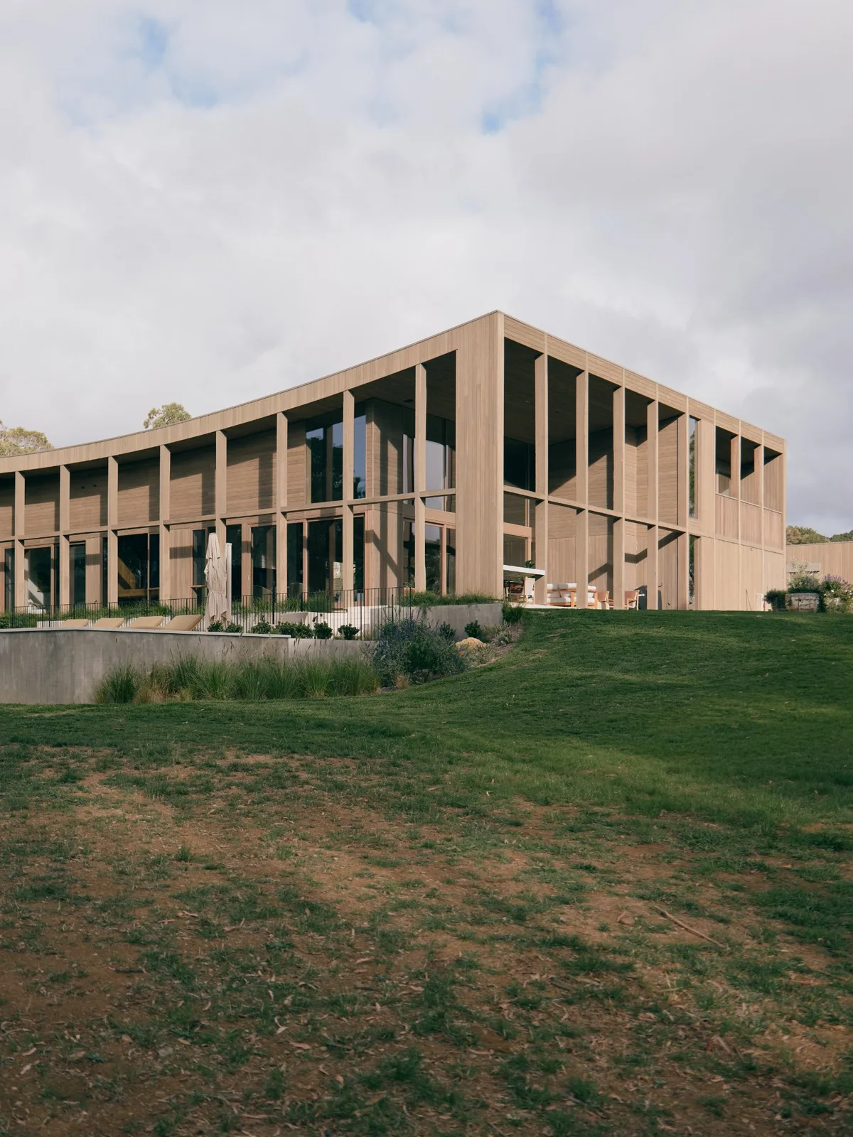 The Farm, Shoreham. The curved timber elevation above the paddock.